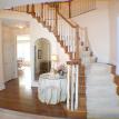 Elegant Entrance Foyer with Stained Railings and Stair Caps